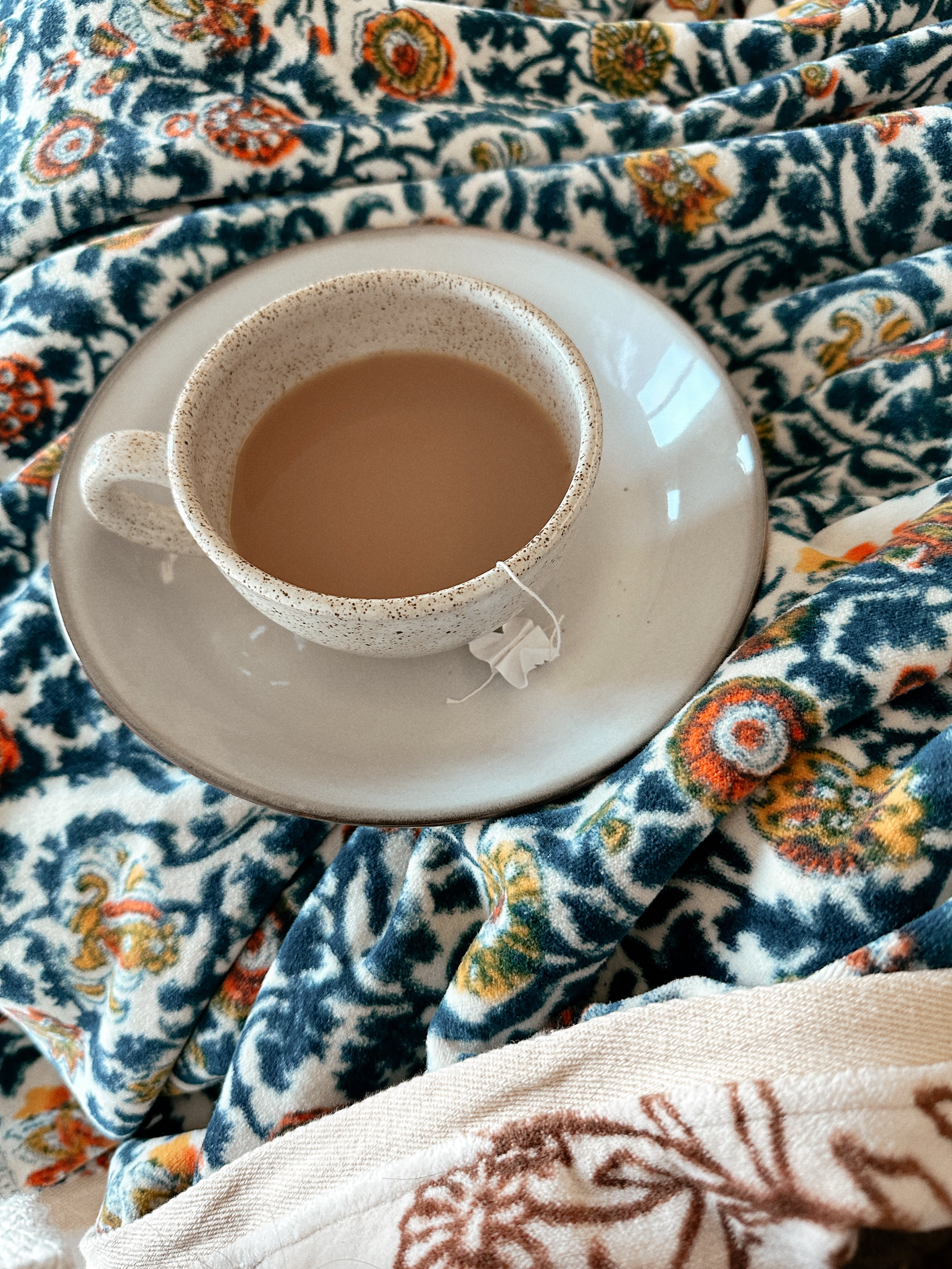 Block printed velvet blanket with a cup of tea sitting atop