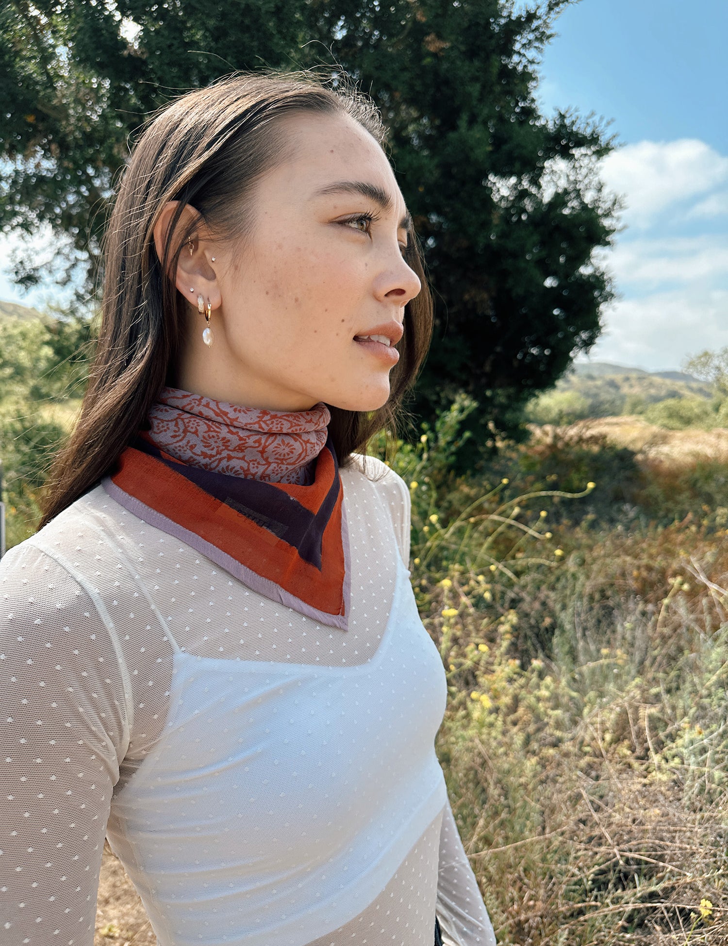 Block printed floral printed Eva bandana tied around neck, styled with white sheer long sleeve