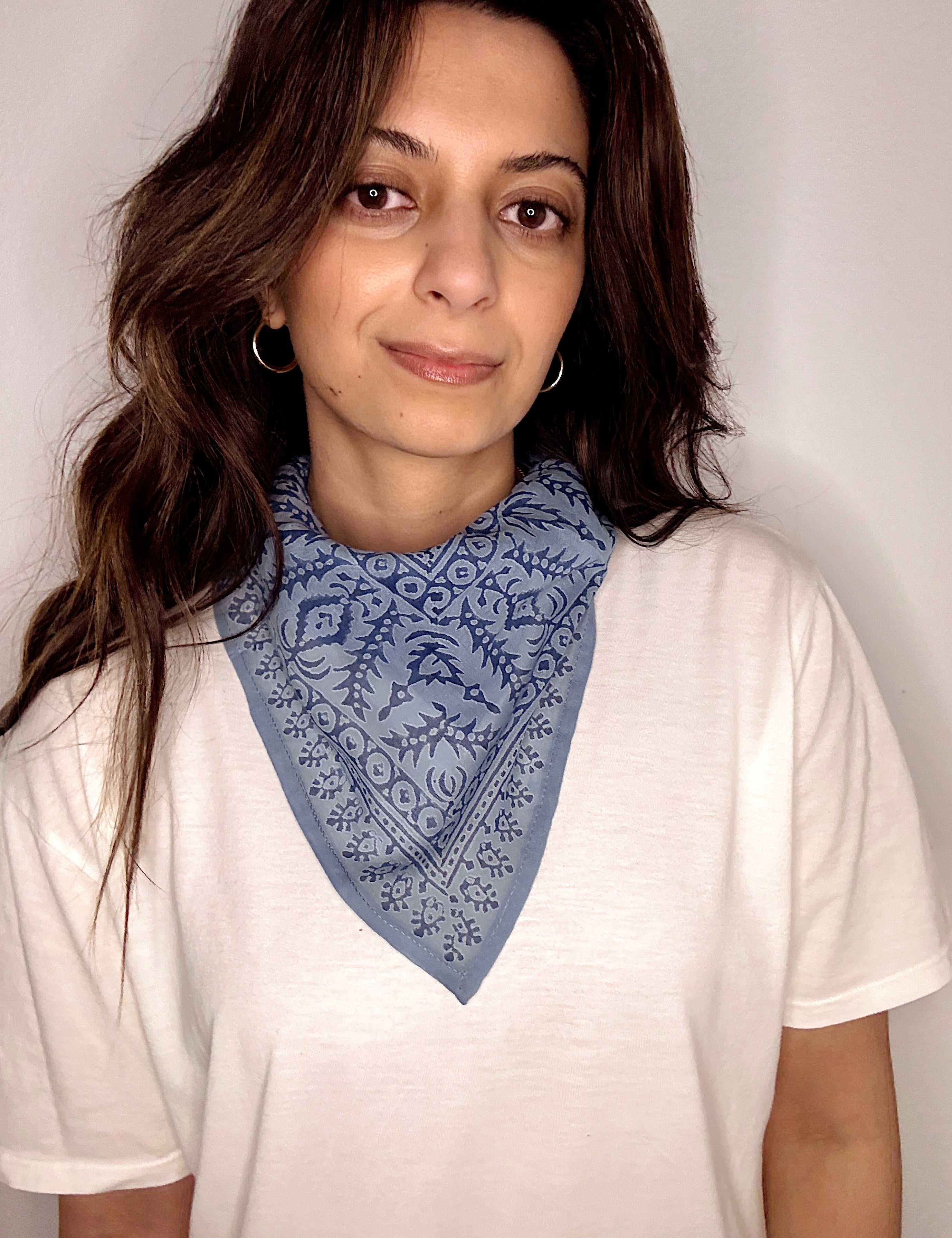 Woman wearing block printed Angelite blue bandana around the neck