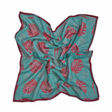 Block printed Monstera bandana, laid flat and scrunched up. Bandana has a red leaf print.