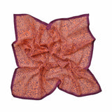 Block printed Amber bandana, laid flat scrunched up. Bandana has an all over floral print.