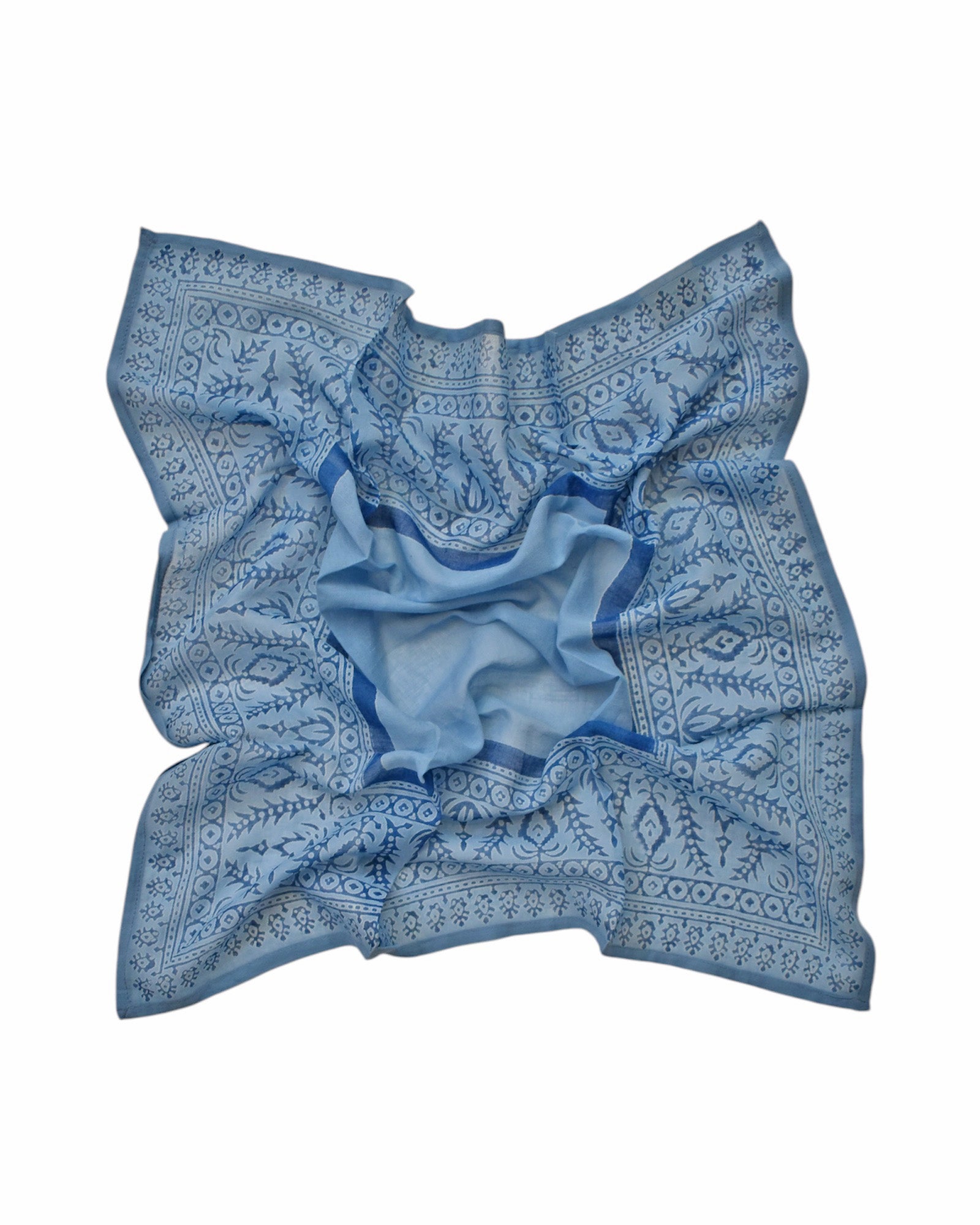 Block printed Angelite bandana, laid flat and scrunched up. Bandana has a floral print.