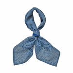 Block printed Angelite bandana, tied up. Bandana has a floral print.