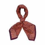 Block printed Amber bandana, tied up. Bandana has an all over floral print.