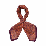 Block printed Amber bandana, tied up. Bandana has an all over floral print.