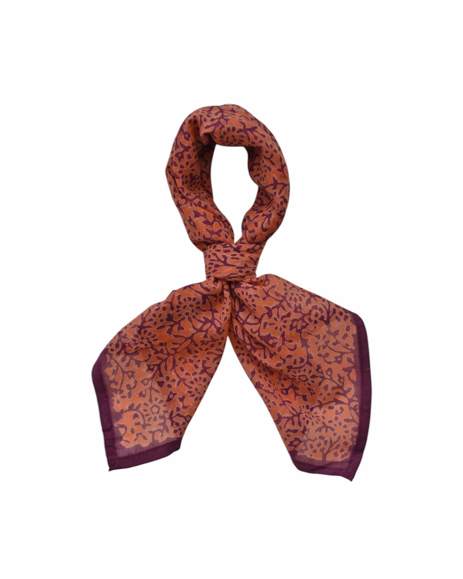 Block printed Amber bandana, tied up. Bandana has an all over floral print.