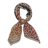 Block printed geometric and floral print Roma bandana, tied flat against a white background