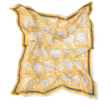 Tate yellow block printed floral bandana laid flat against a white background