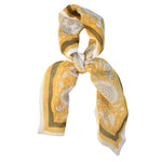 Tate yellow block printed floral bandana tied flat against a white background