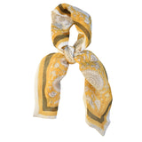Tate yellow block printed floral bandana tied flat against a white background