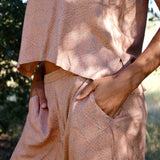 Close up of the Alba set, focus on hands in side pockets