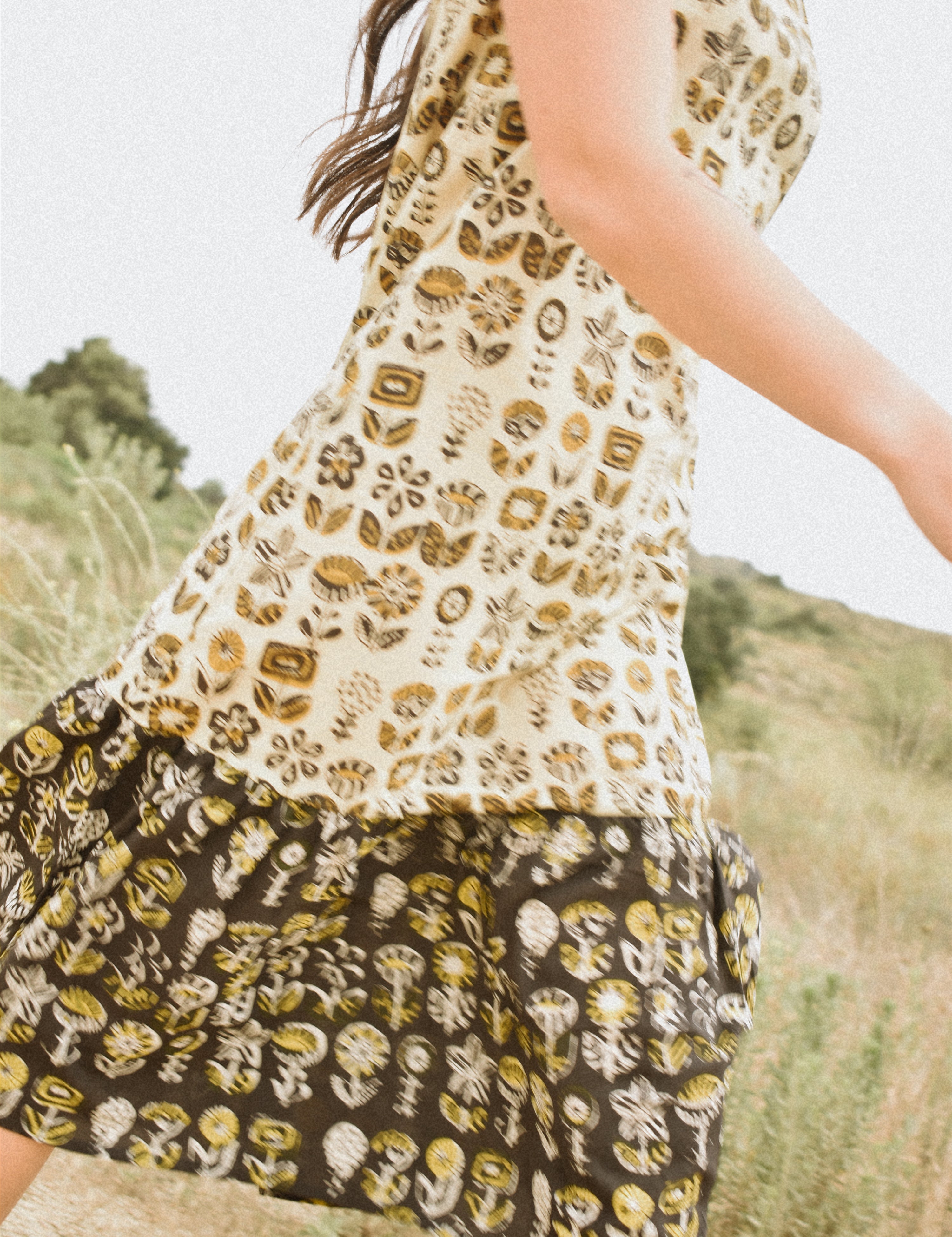 Woman wearing floral block printed sleeveless ruffle dress