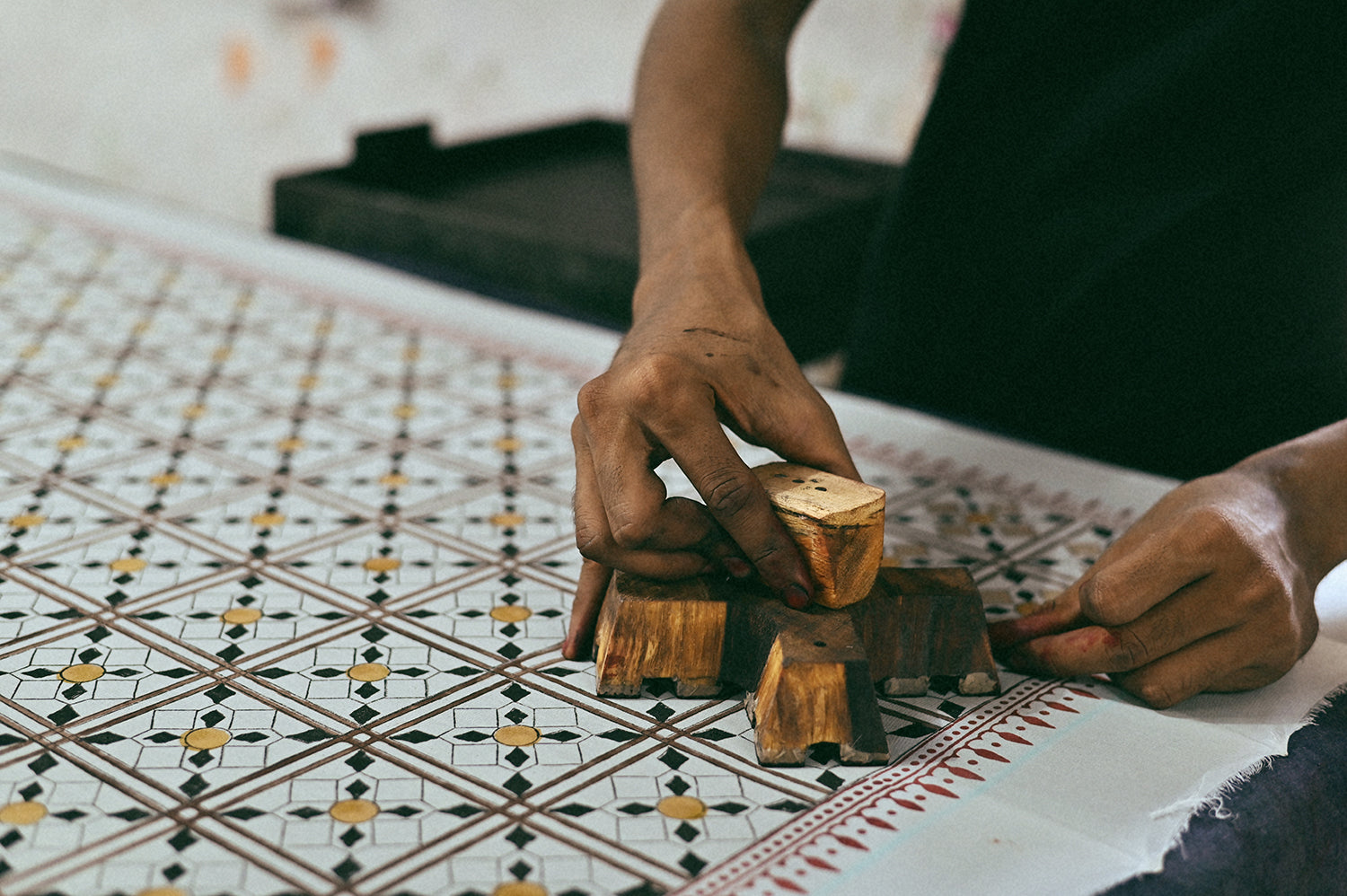 Artist block printing on fabric