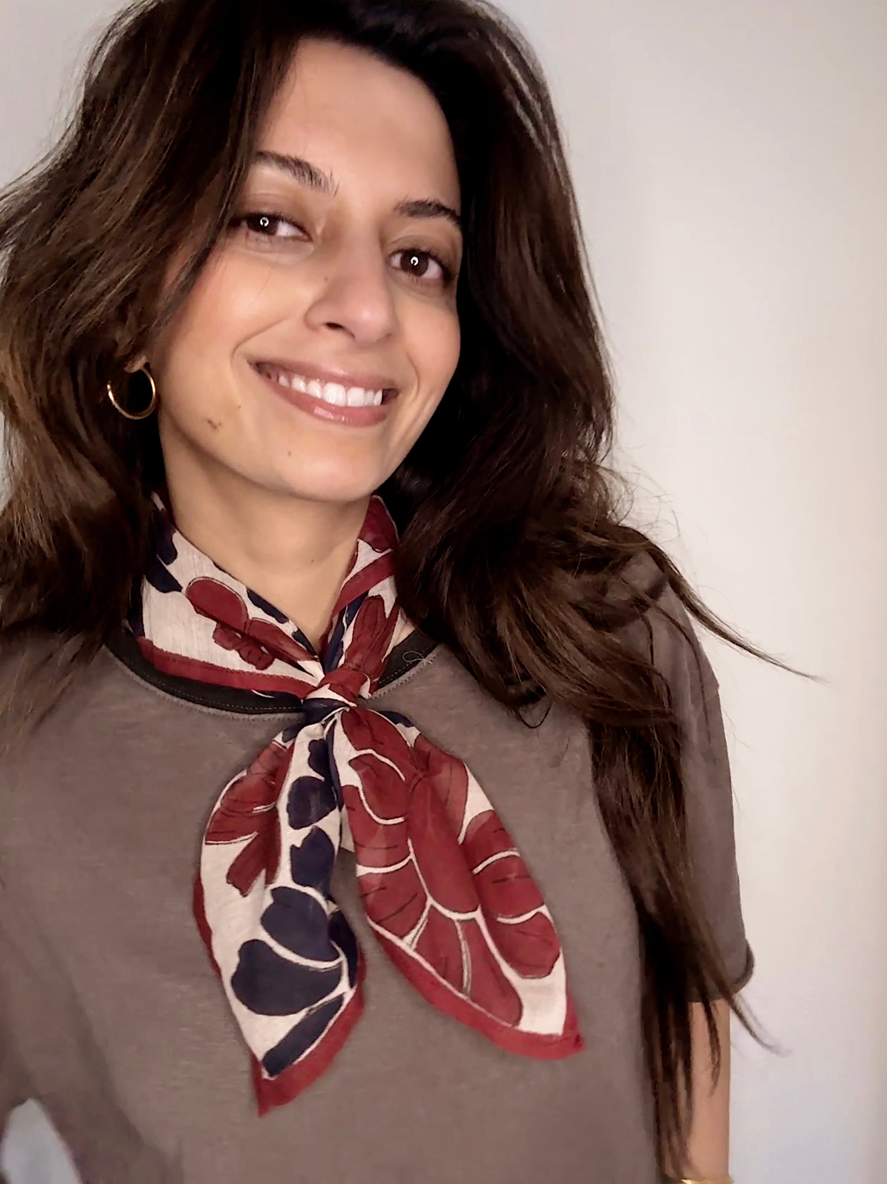 Woman wearing block printed floral Flora bandana around the neck