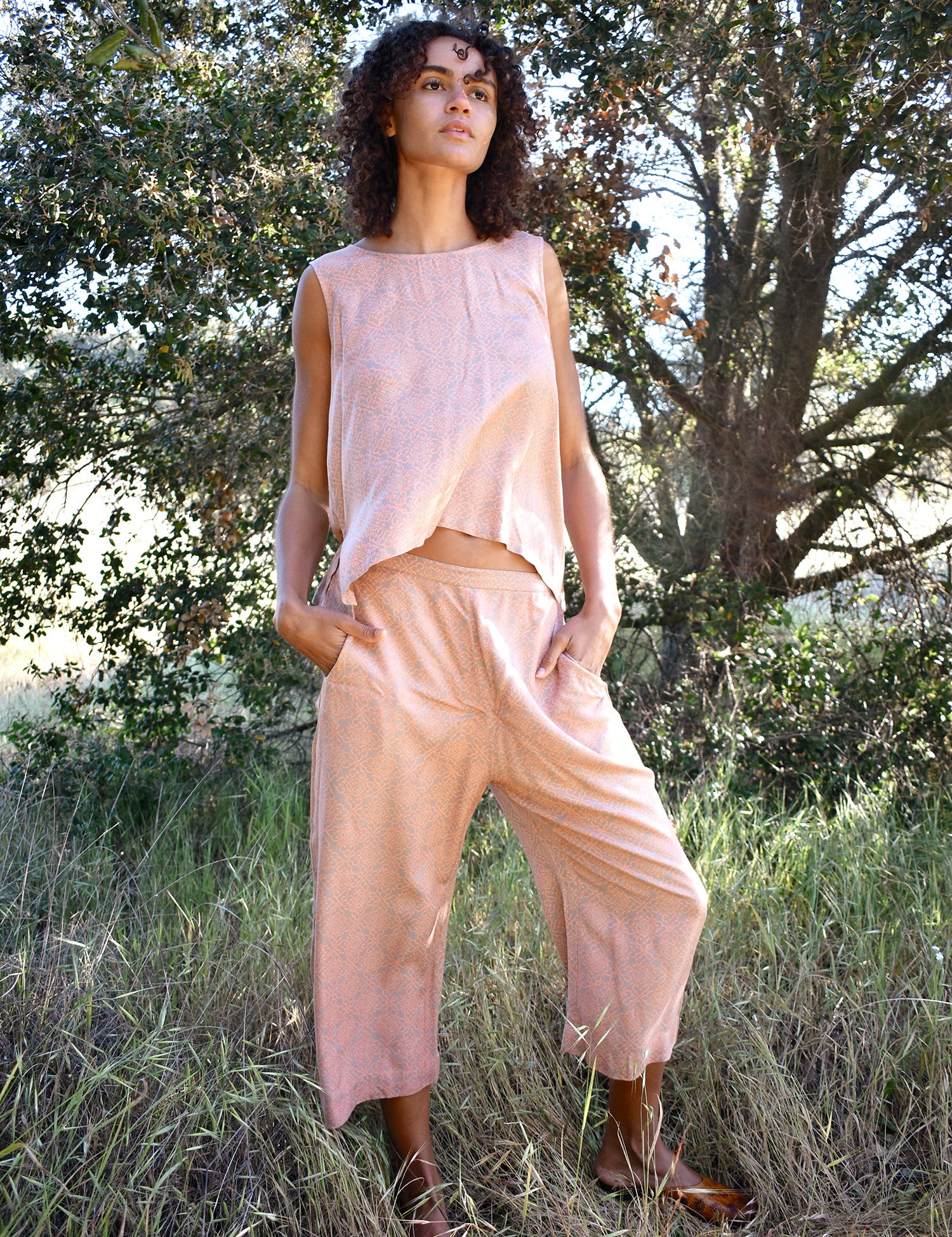 Woman wearing Alba Set, standing outside with trees in the background