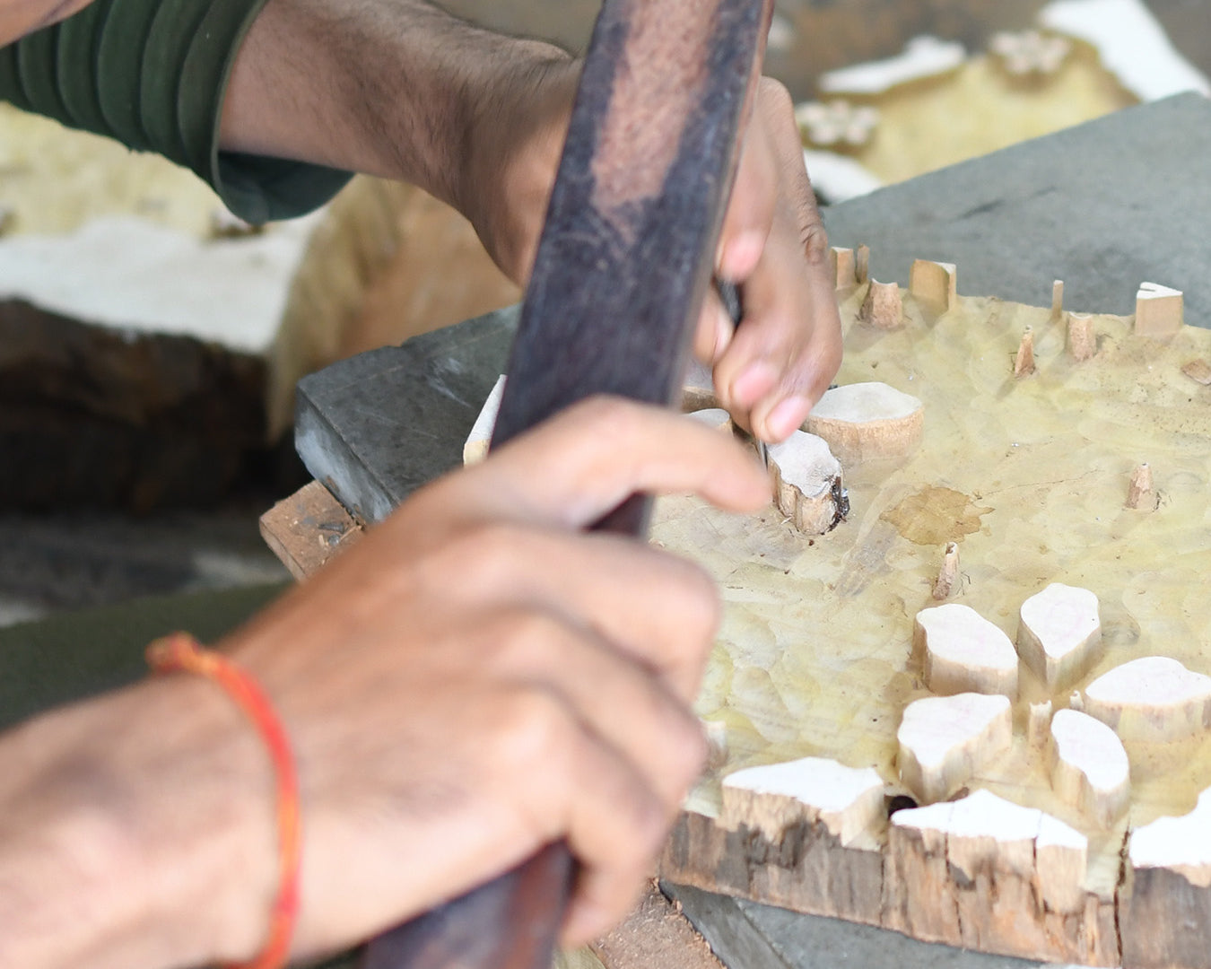 Artist carving out wooden block