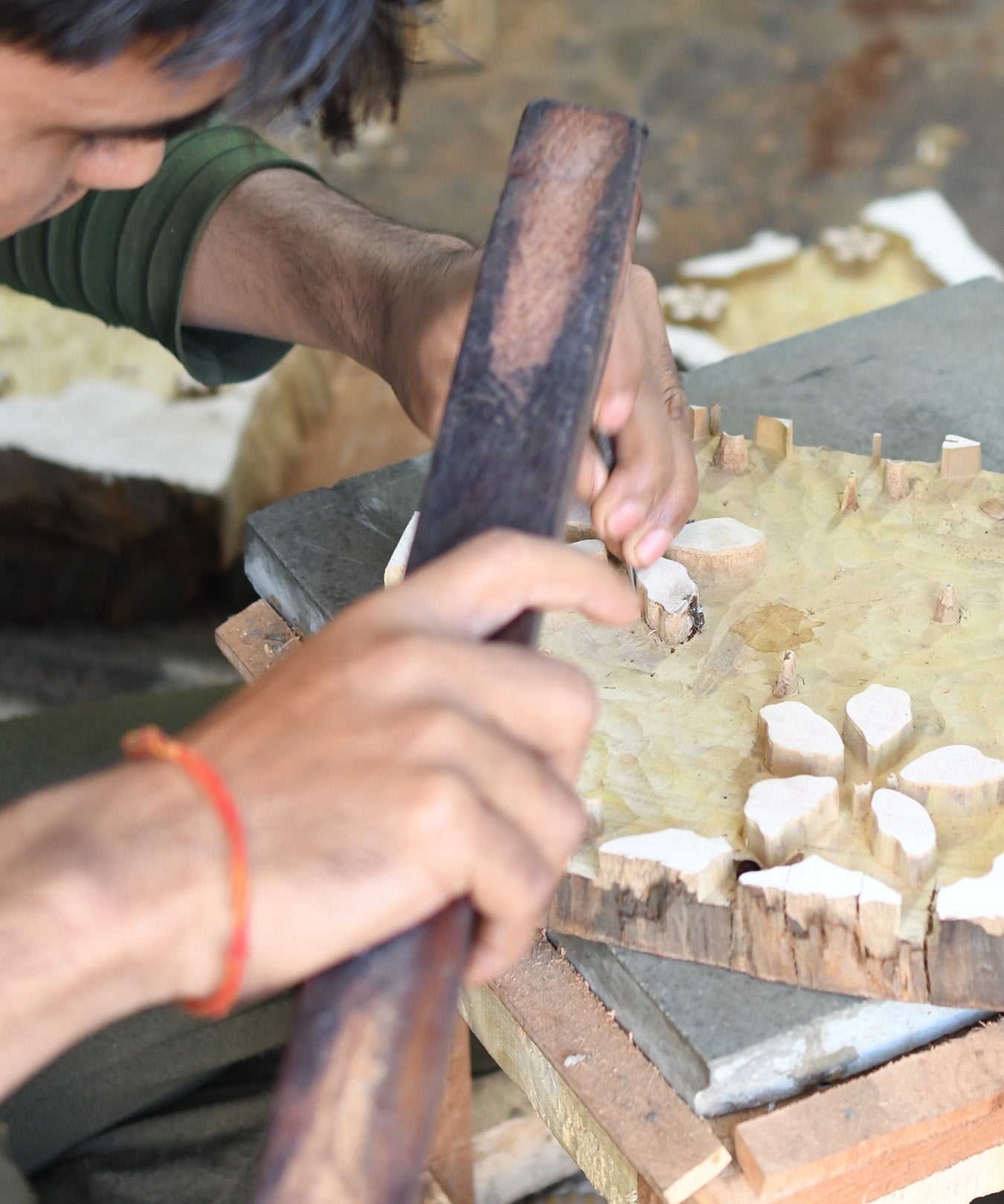 Artist carving out wooden block