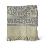 Grey bath towel with floral pattern and fringe on a white background