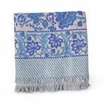 Blue and white patterned bath towel with fringes on a white background