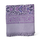 Floral printed purple bath towel folded on white background