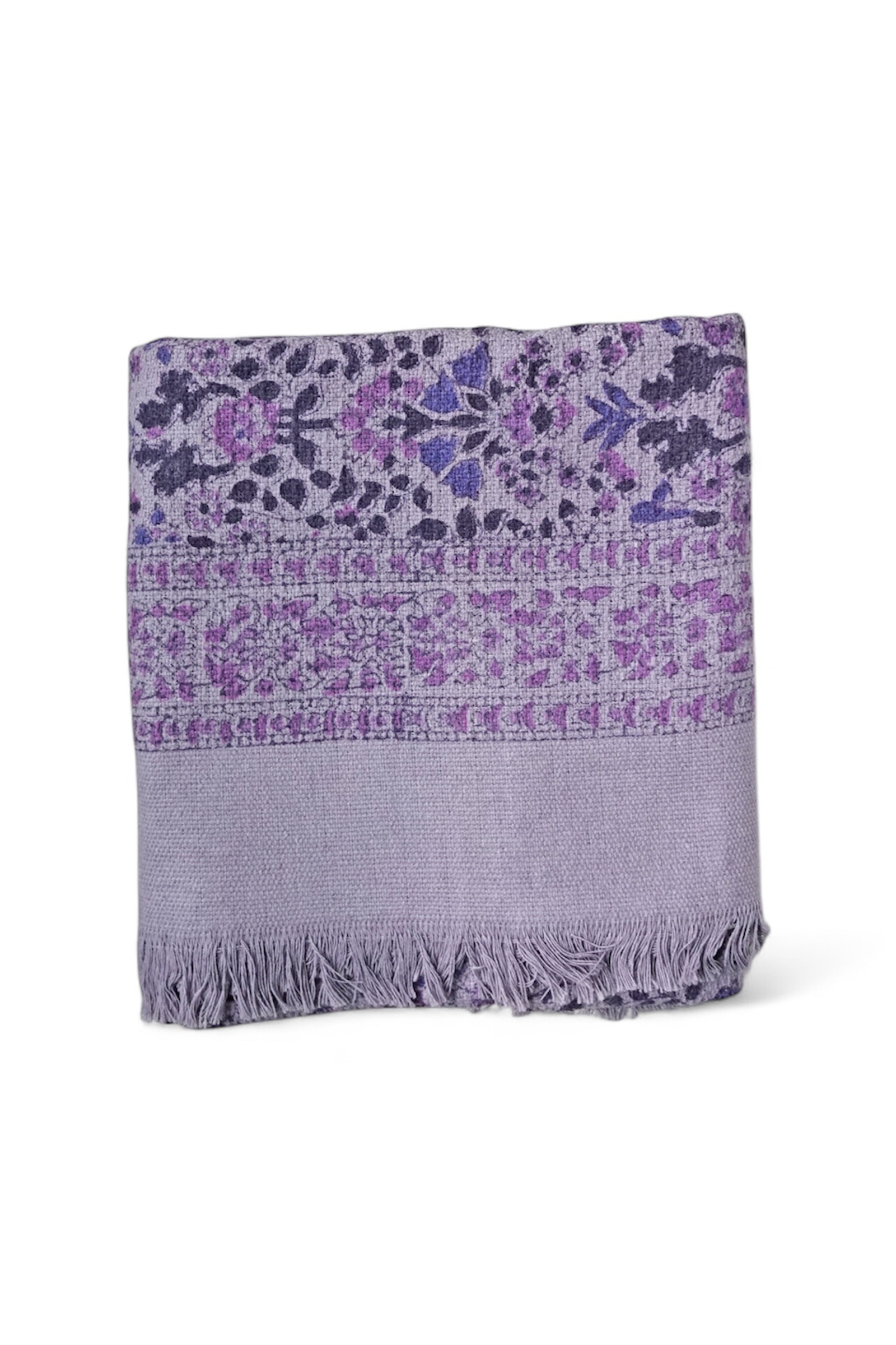 Floral printed purple bath towel folded on white background