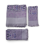 Purple floral patterned bath towel and hand towels folded on white background