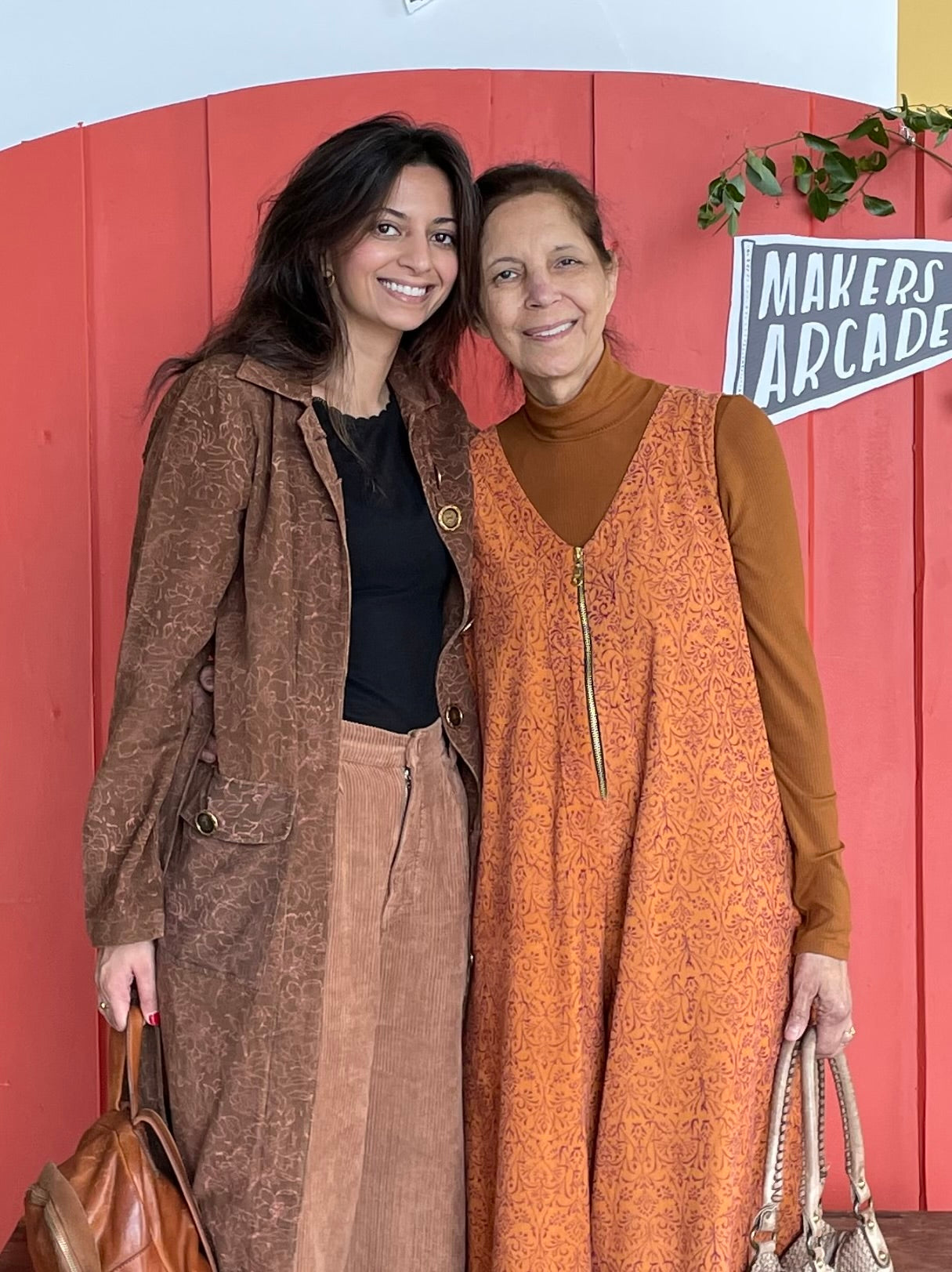 Nargis and her mother standing in front of Maker's Arcade sign