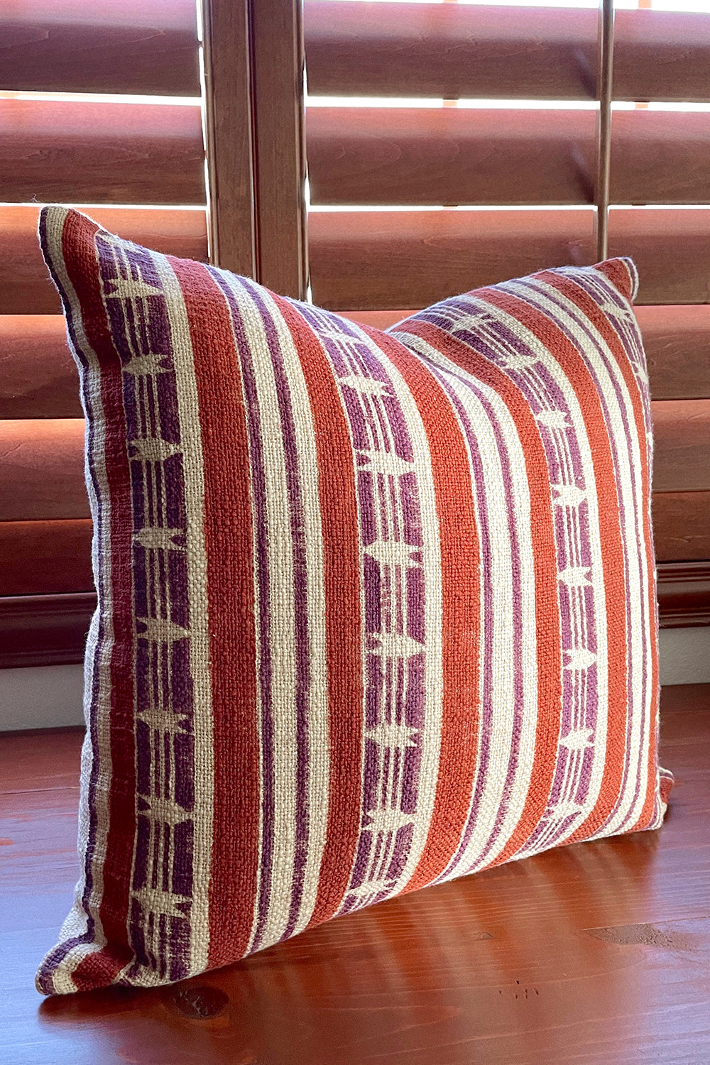 Mojave block print pillow on a wooden desk, angled