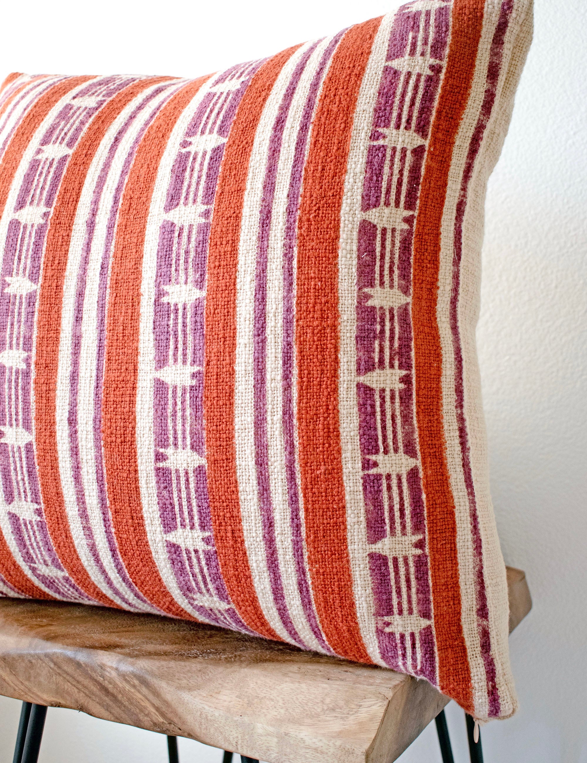 Mojave block print pillow on a stool against white, angled