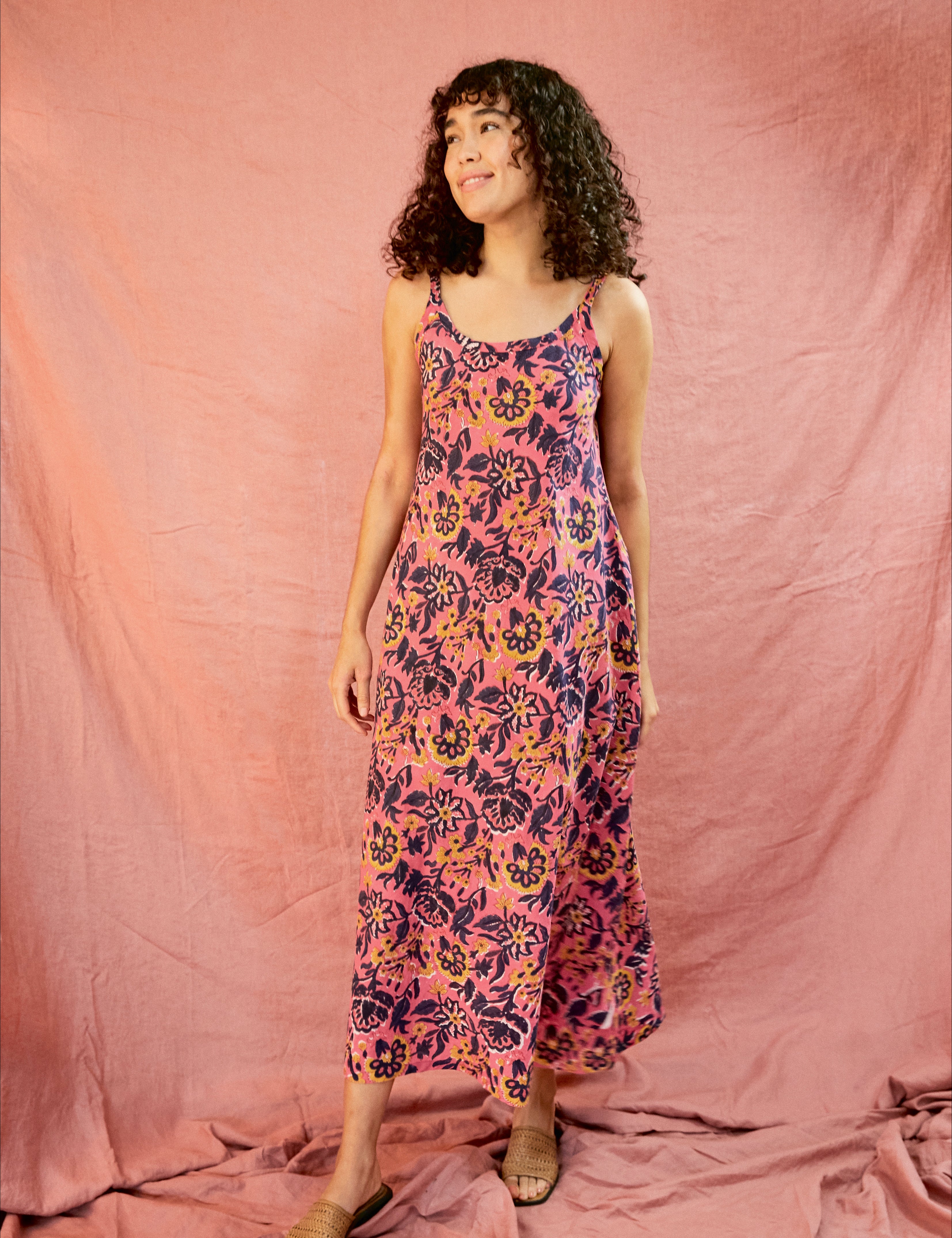 Model wearing the Kate strap dress against a blush background