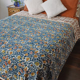 Winter Wonderland Reversible Velvet Blanket draping a full size bed, back print