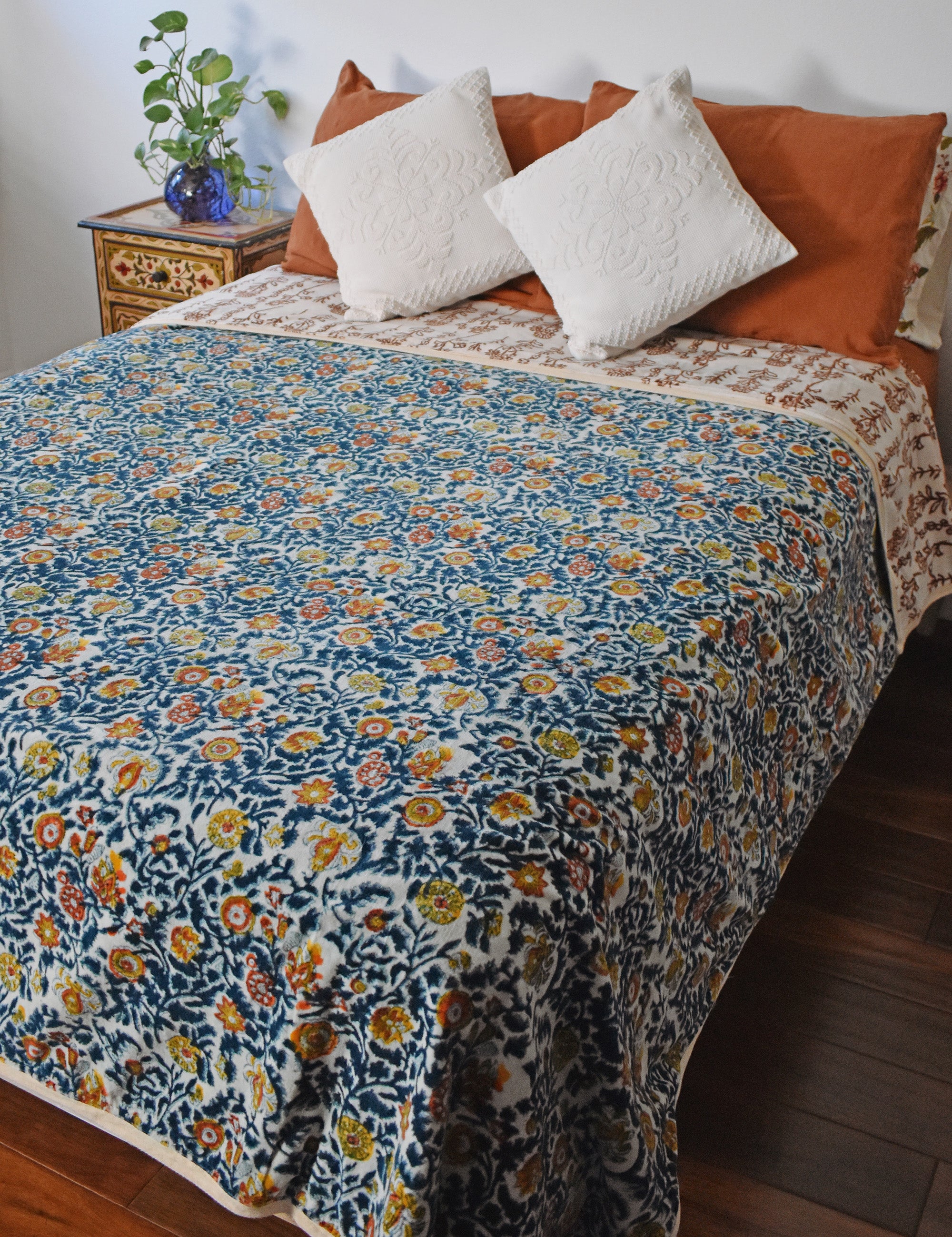Winter Wonderland Reversible Velvet Blanket draping a full size bed, back print
