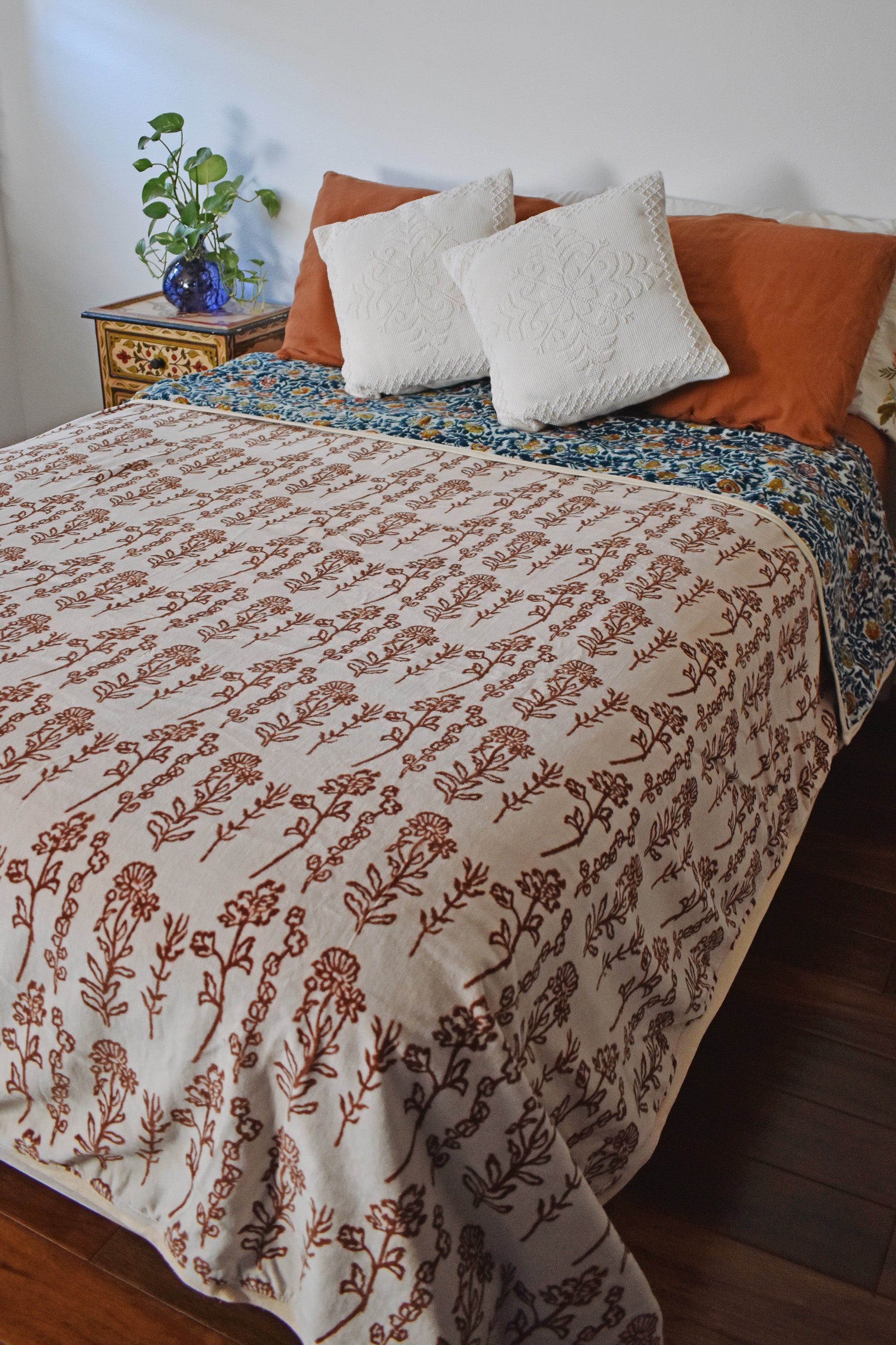 Winter Wonderland Reversible Velvet Blanket draping a full size bed, front print