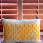 Sol Block Print Pillow on a wooden table