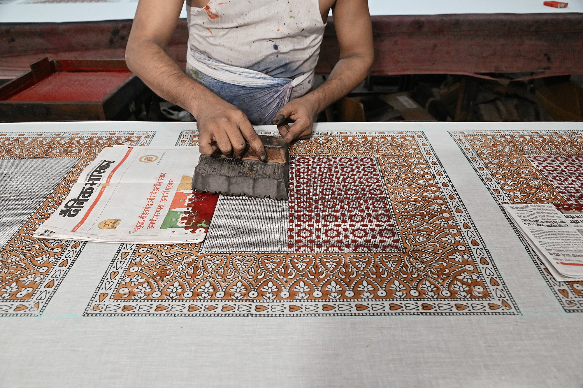 Artist block printing a cotton bandana