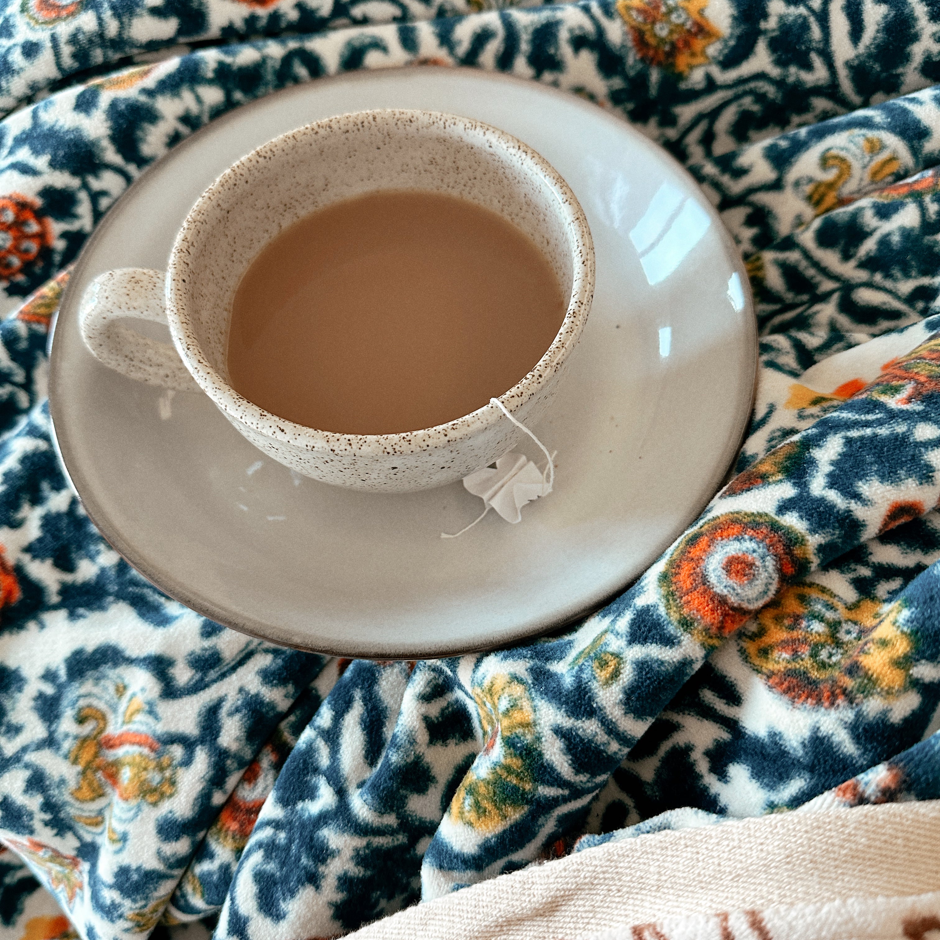 Block printed velvet blanket with a cup of tea sitting atop