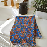 One Adria block printed hand towel folded and placed on a white bathroom counter