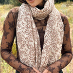 Block printed floral printed chunky wool scarf wrapped around neck, styled with sheer brown long sleeve