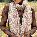 Block printed floral printed chunky wool scarf wrapped around neck, styled with sheer brown long sleeve