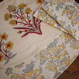 Floral-patterned placemats and napkins on a wooden surface