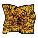 Chai bandana scarf laid flat on white background. Scarf has a blueish black background and large golden floral print allover.