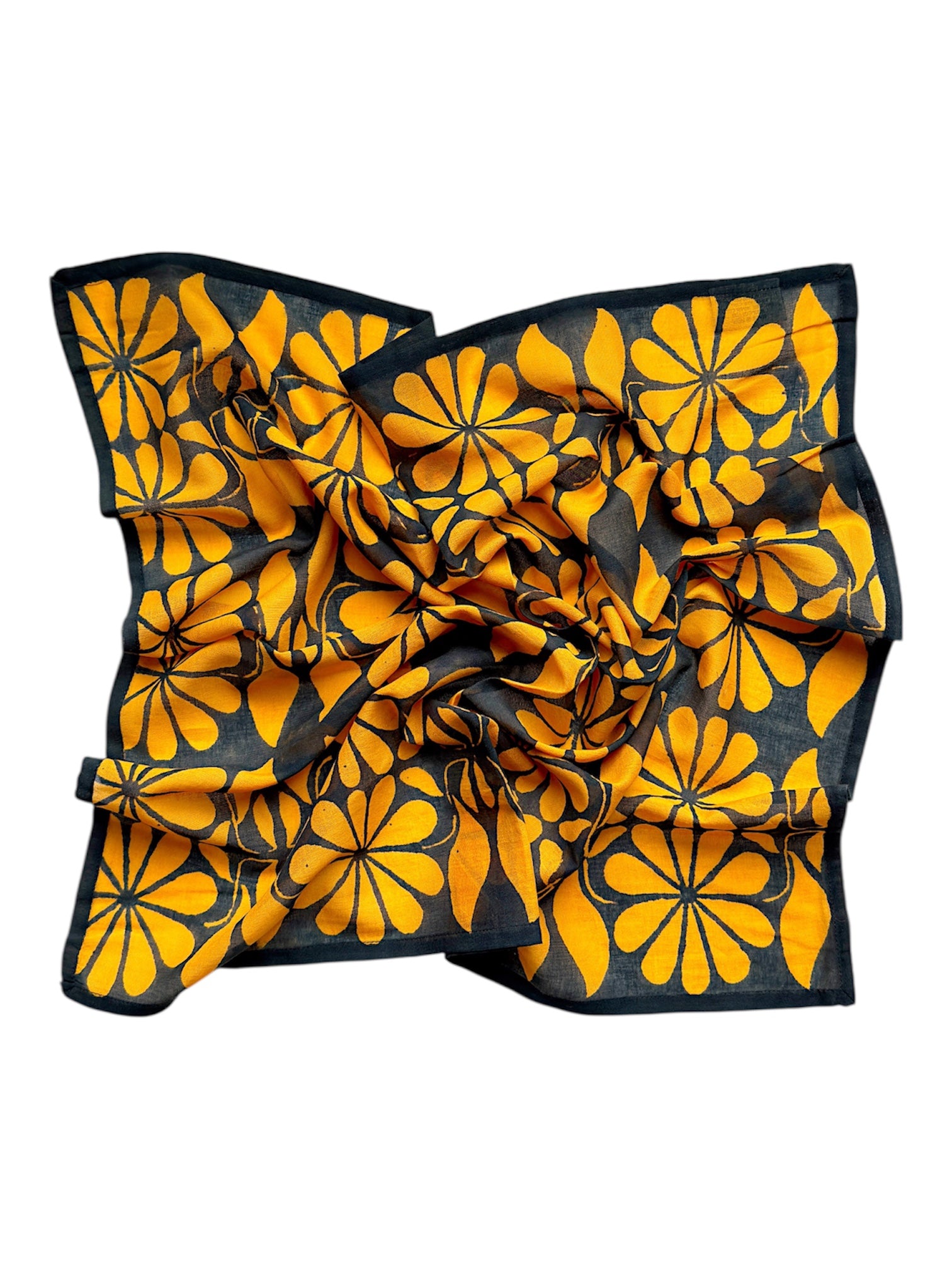 Chai bandana scarf laid flat on white background. Scarf has a blueish black background and large golden floral print allover.