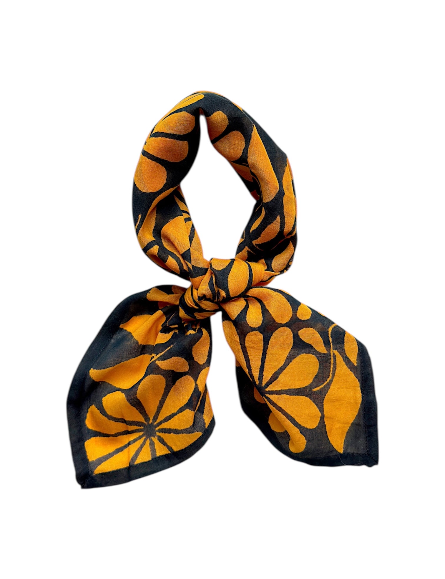 Chai bandana scarf tied on white background. Scarf has a blueish black background and large golden floral print allover.