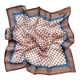 Checkered bandana scarf with brown and white pattern laid flat on a white background