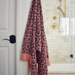 Block printed diamond design waffle weave bath towel hanging on a hook