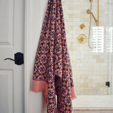 Block printed diamond design waffle weave bath towel hanging on a hook