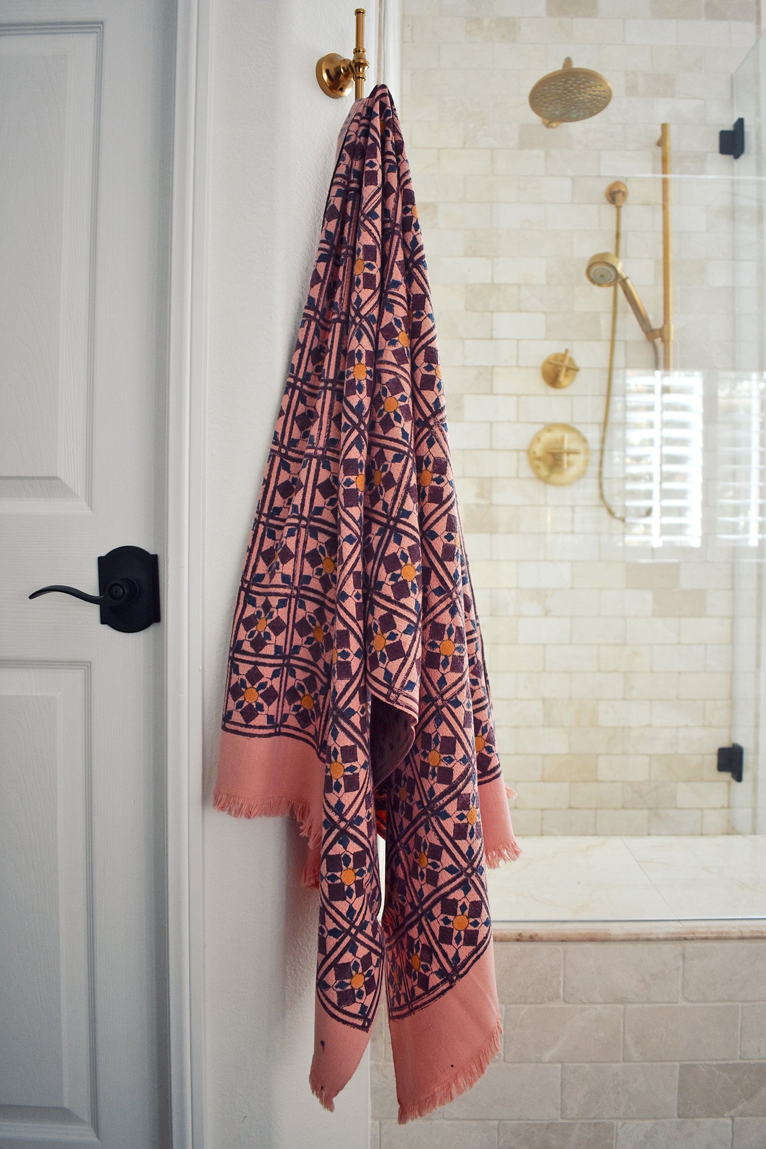 Block printed diamond design waffle weave bath towel hanging on a hook