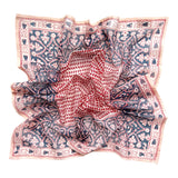 Decorative block printed bandana scarf with blue and red floral print, laid flat on a white background