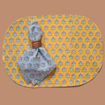 Block printed Blossom cotton placement, reversible side. Print is a smaller floral print. Blue floral printed napkin is styled on top.