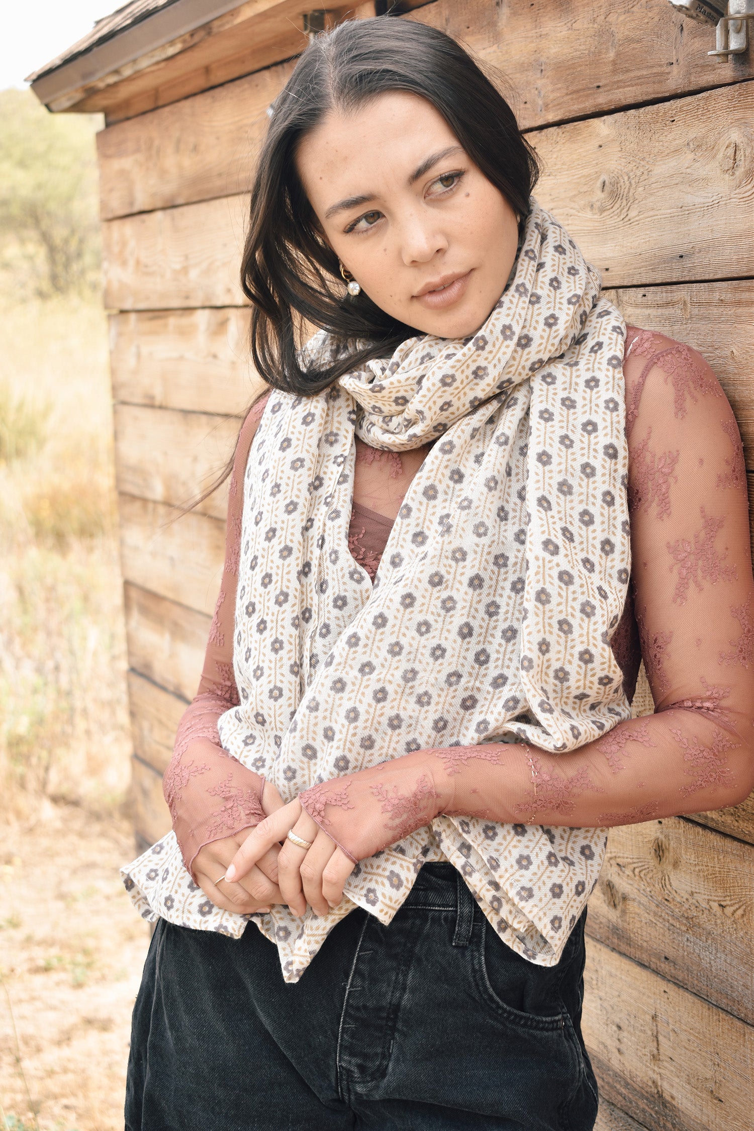 Block printed floral printed chunky wool scarf styled around the neck, worn with sheer rose long sleeve and jeans